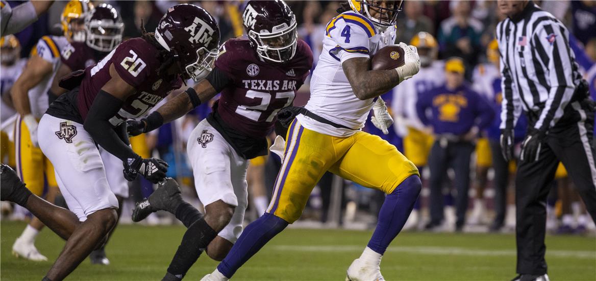 LSU Tigers running back John Emery Jr. (4) and Texas A&M Aggies defensive back Jardin Gilbert (20) and defensive back Antonio Johnson (27) in action during the game between the Texas A&M Aggies and the LSU Tigers at Kyle Field. Jerome Miron-USA TODAY Sports

                    