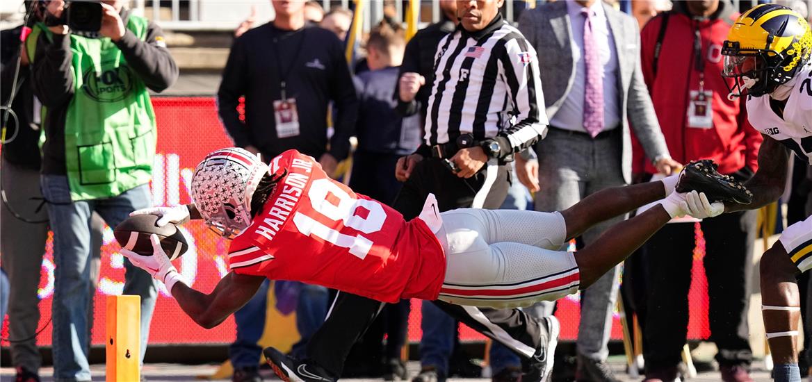 Ohio State Buckeyes wide receiver Marvin Harrison Jr. (18) catches a touchdown pass behind Michigan Wolverines running back Tavierre Dunlap (22) during the first half of the NCAA football game at Ohio. Adam Cairns-The Columbus Dispatch

                    