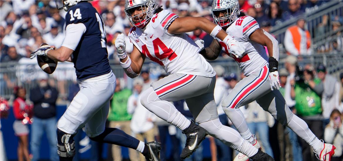 Ohio State Buckeyes defensive end J.T. Tuimoloau (44) pursues Penn State Nittany Lions quarterback Sean Clifford (14) during the first half of the NCAA Division I football game at Beaver Stadium.  Adam Cairns-The Columbus Dispatch

                    