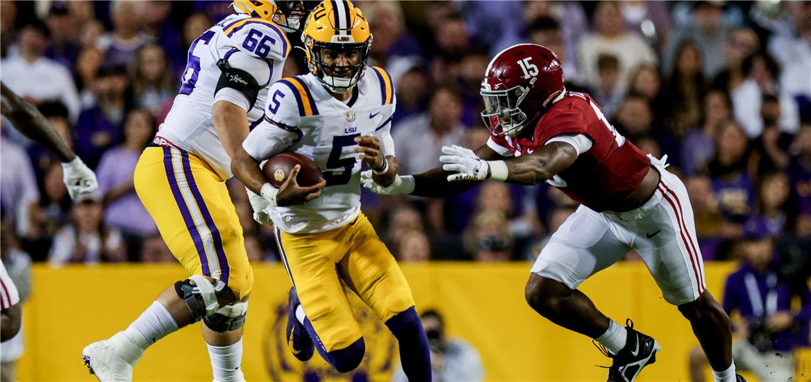 LSU Tigers quarterback Jayden Daniels (5) scrambles out the pocket against Alabama Crimson Tide linebacker Dallas Turner (15) during the first half at Tiger Stadium. Stephen Lew-USA TODAY Sports